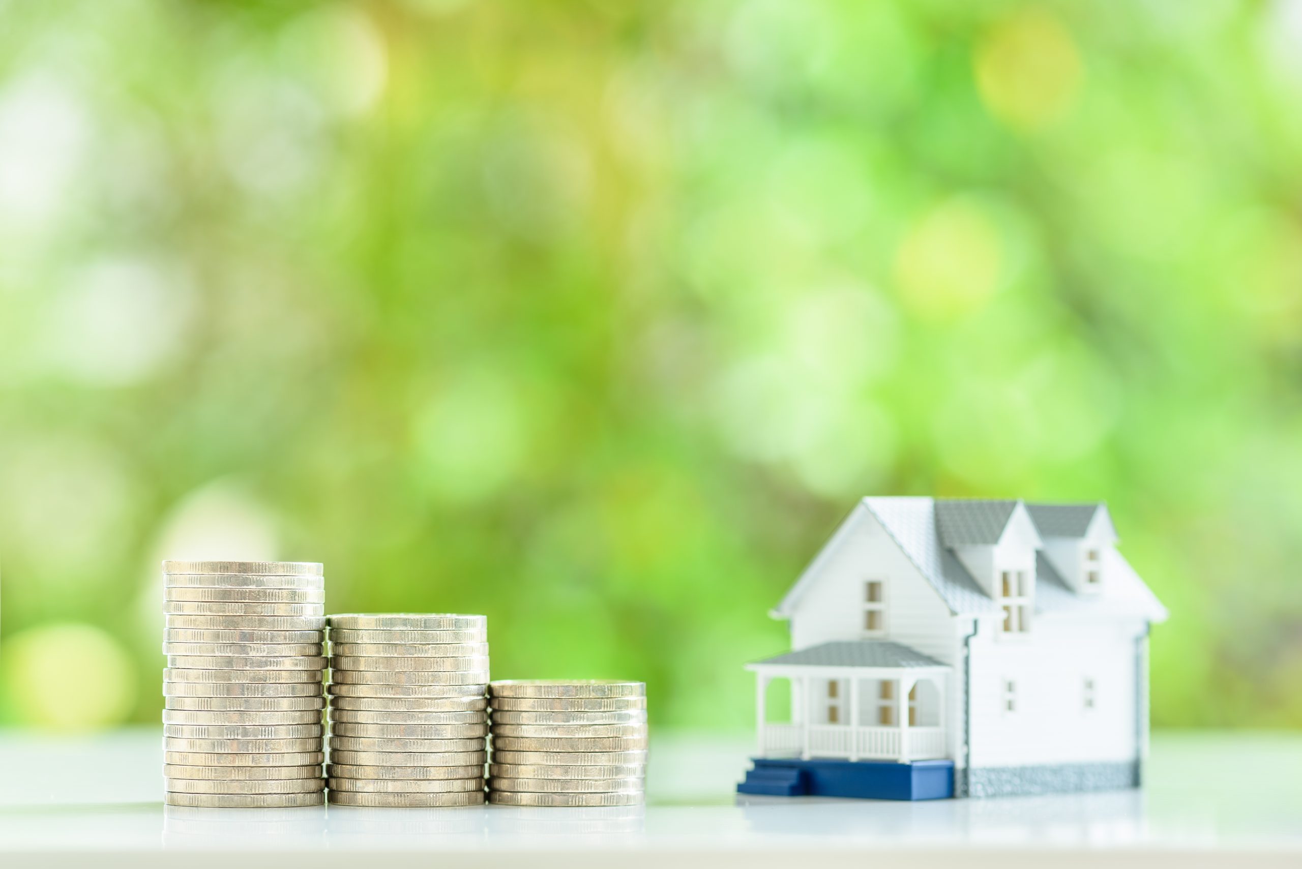 Home for sale, reverse mortgage, rent to own agreement, financial concept : Two-story model house on a wood floor, depicting a buyer purchases a residential asset to live and invest for personal gain.
